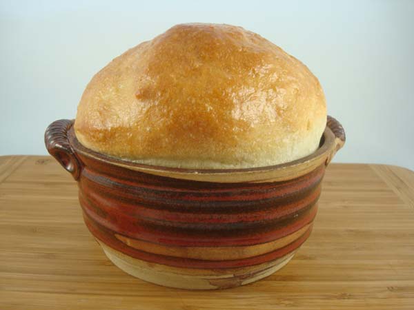 stoneware bread bowl with dome of golden yeast bread